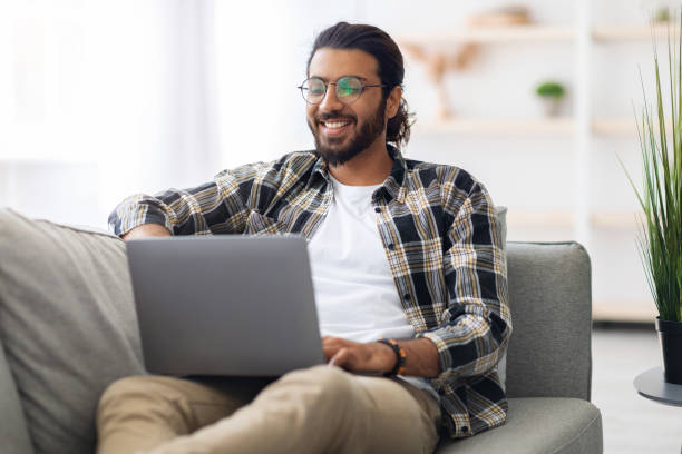 istock happy middle-eastern man freelancer enjoying his online job 1350010177