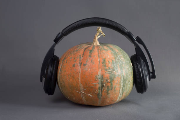 istock pumpkin in headphones isolated on gray background image contains copy space 1350010410