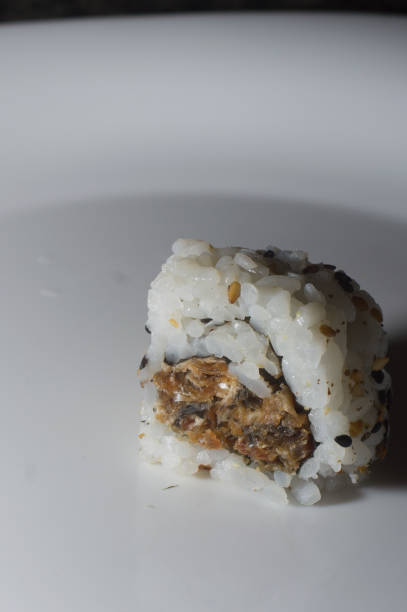 istock uramaki sushi on a white plate with copy space, selective focus 1350010523