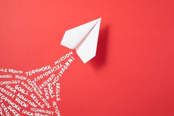istock Paper Airplane on Red Background 1350010580