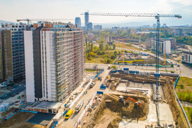 istock Industrial construction cranes and construction in Sofia, Bulgaria. Aerial view of construction site and construction machinery. Drone point of view 1350010651