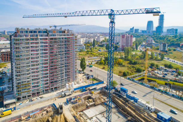 istock Industrial construction cranes and construction in Sofia, Bulgaria. Aerial view of construction site and construction machinery. Drone point of view 1350010658