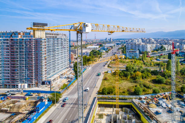 istock Industrial construction cranes and construction in Sofia, Bulgaria. Aerial view of construction site and construction machinery. Drone point of view 1350010672