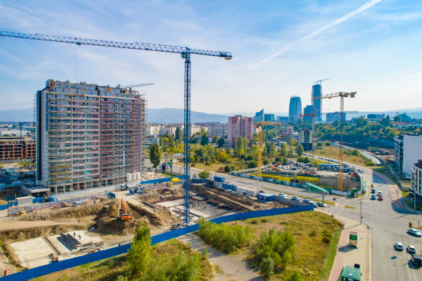 istock Industrial construction cranes and construction in Sofia, Bulgaria. Aerial view of construction site and construction machinery. Drone point of view 1350010687