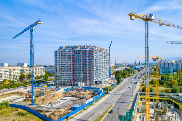 Industrial construction cranes and construction in Sofia, Bulgaria. Aerial view of construction site and construction machinery. Drone point of view