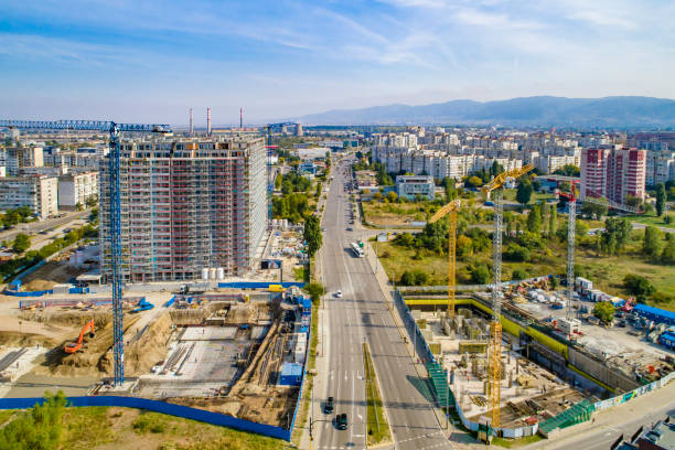 istock Industrial construction cranes and construction in Sofia, Bulgaria. Aerial view of construction site and construction machinery. Drone point of view 1350011247