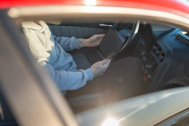istock young man with laptop in car 1350011564