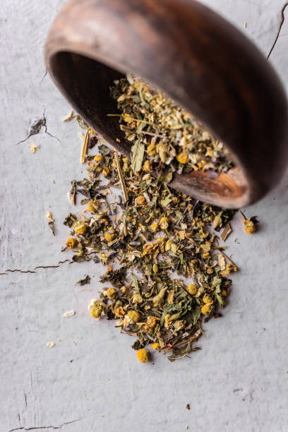 istock selective focus, natural green leaf tea in a wood bowl 1350011658