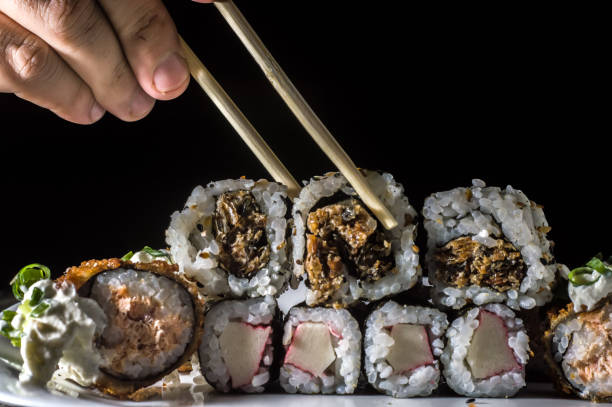 istock sushi, several types of sushi on a white plate and black background 1350013880