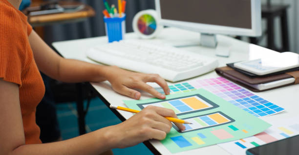 istock Mobile app user interface designer at desk job working in office. 1350022735