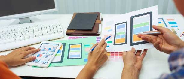istock Mobile app user interface designer at desk job working in office. 1350022780