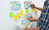 App designers work together to plan user interface layouts for mobile apps.