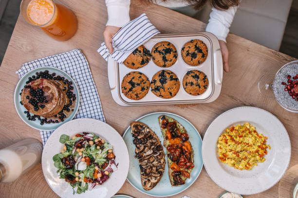 istock Woman setting the table with vegan food 1350022873