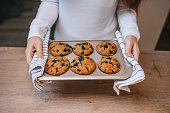 Woman putting vegan muffins on table