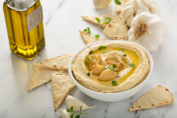 istock Roasted garlic hummus topped with olive oil 1350023931