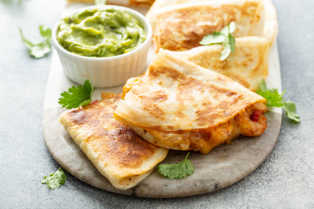 istock Shrimp and cheese quesadillas served with guacamole 1350023999