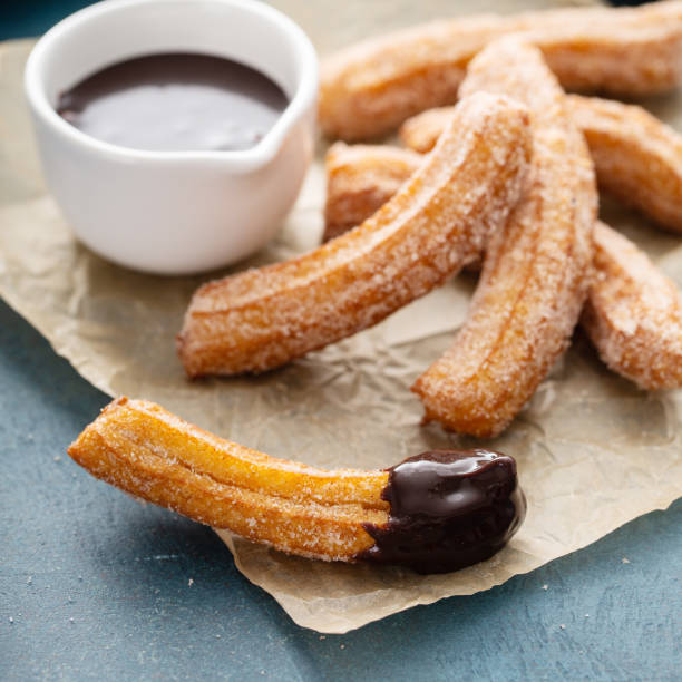 istock Homemade churros with cinnamon sugar on parchment 1350024004