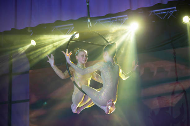 istock Circus actress acrobat performance. Two girls perform acrobatic elements in the air ring. 1350024270
