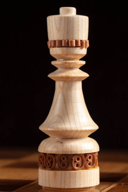 istock Chess queen on a black background. A puzzle game with tricky combinations that requires planning and thinking. 1350024371