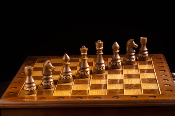 istock Chess on a dark background. A puzzle game with tricky combinations that requires planning and thinking. 1350024426