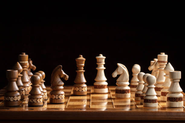 istock Chess on a dark background. A puzzle game with tricky combinations that requires planning and thinking. 1350024479