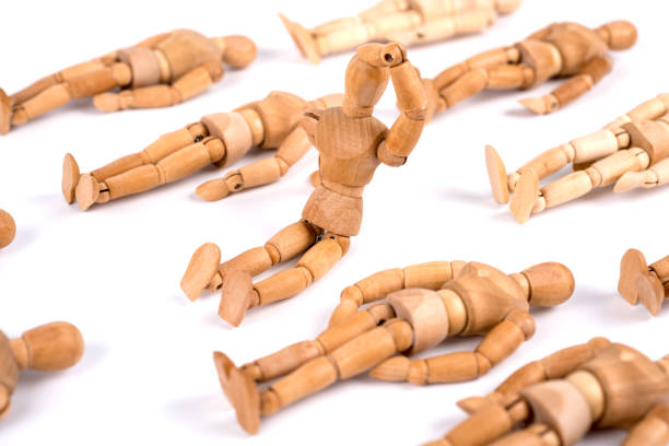 istock Wooden mannequin sleeping in a group and one woke up 1350025489