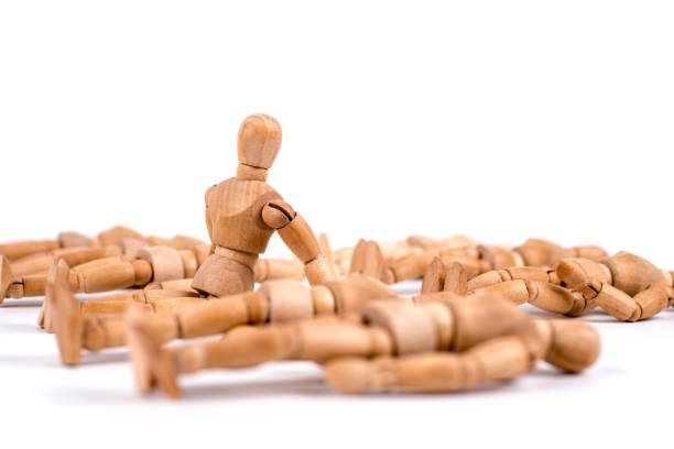 istock Wooden mannequin sleeping in a group and one woke up 1350025533