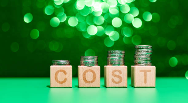 istock Heap of coins on word cost 1350026667