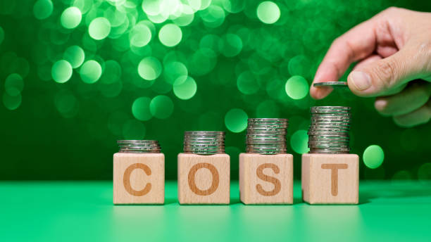 istock Heap of coins on word cost 1350026702