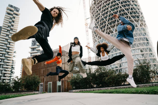 istock Five cool friends are jumping in a modern location 1350027360