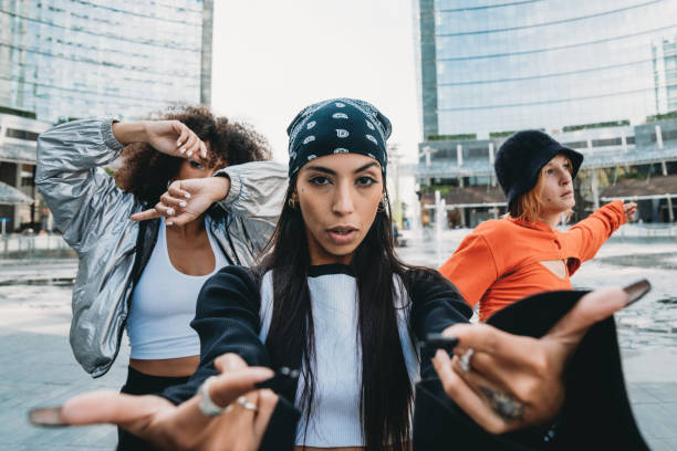 Three female dancer friends are posing in a modern city Three female dancer friends are posing in a modern city. Cool attitude. Multi ethnic group of people. hip hop stock pictures, royalty-free photos & images