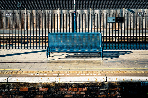 Metal bench seats on a railway station train platform