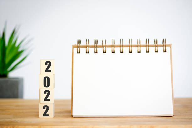 istock 2022 time to start up, plan for new year with cubes wooden, space for your text on notepad, mockup calendar and tree is next, mean to growth start new in your life. 1350031044