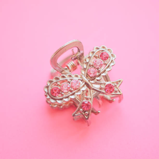 istock Silver butterfly crab hairpin with stones on a pink table 1350031593