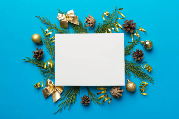 istock Flat lay Christmas composition. square Paper blank, pine tree branches, christmas decorations on Colored background. Top view, copy space for text 1350032216
