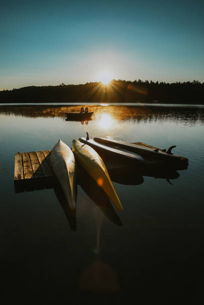istock Kayaks and SUPs resting on a dock on a lake at sunrise. 1350033542