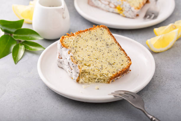 Lemon Poppy Seed Pound Cake with powdered sugar glaze Lemon Poppy Seed Bundt Cake with powdered sugar glaze. A slice of cake on a plate. poppy seed stock pictures, royalty-free photos & images