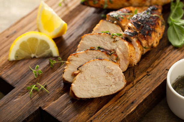 Balsamic grilled chicken breast on a board stock photo