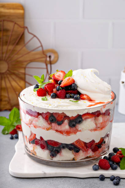 Summer berry trifle with angel food cake in a large bowl Summer berry red, white and blue trifle with angel food cake in a large bowl. Dessert for 4th of July, Independence day sweet treat trifle stock pictures, royalty-free photos & images