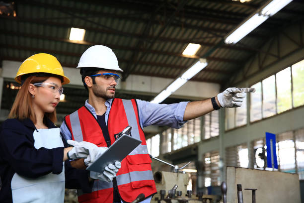 istock Supervisor and engineer wearing safety uniform and equipment discussion at work shop or factory 1350035501