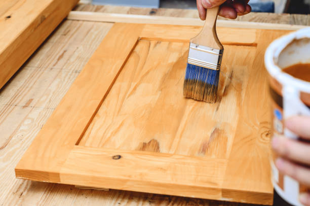 istock Painting a wooden surface with a brush 1350037795