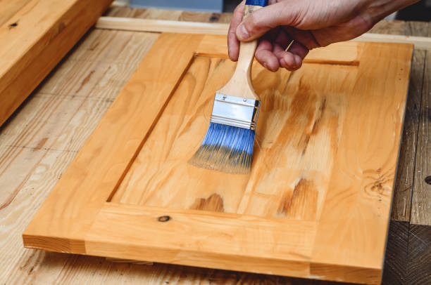istock Painting a wooden surface with a brush 1350037810