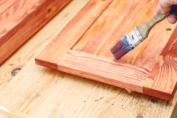 istock Painting a wooden surface with a brush 1350037817