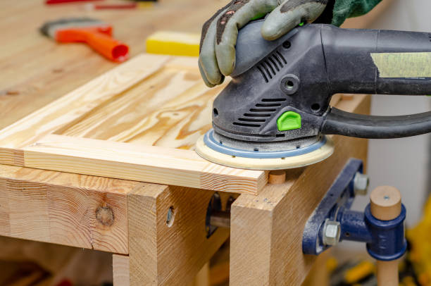 istock Sanding a wooden board with a hand-held electric sander 1350037837