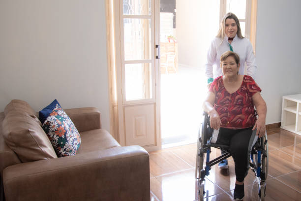 physiotherapist with elderly woman in wheelchair
