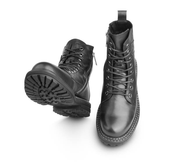Pair of black leather boots isolate on a white Pair of black leather boots, dress boots for men, men ankle high boots, isolate on a white background. With clippig path skin head stock pictures, royalty-free photos & images