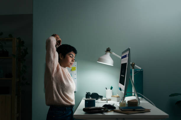 istock Young woman tired in front of computer late at night 1350040258