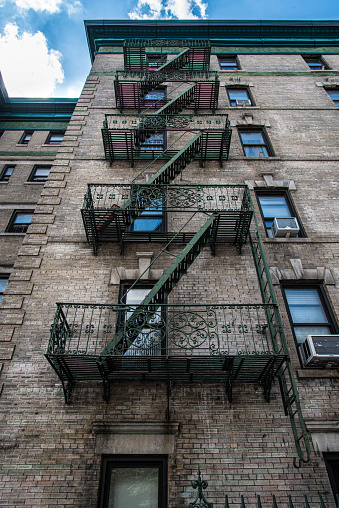 Traditional fire escape ladders at the facade of a New York's apartment, USA