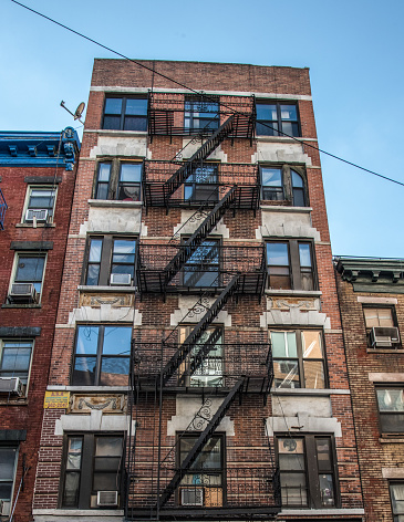 Traditional fire escape ladders at the facade of a New York's apartment, USA