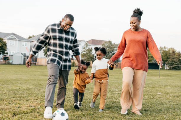 istock Parents and kids playing  soccer together 1350050636